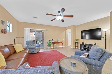 Living room with light tile patterned floors, ceil