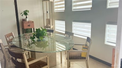 Dining space with healthy amount of natural light and baseboards