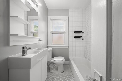 Bathroom featuring vanity, tile patterned floors, and shower / washtub combination