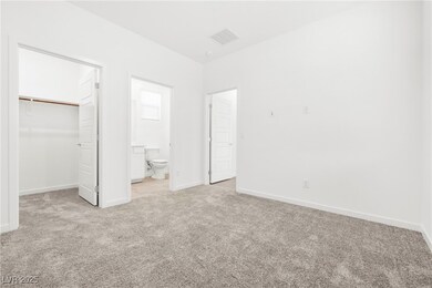 Unfurnished bedroom with light carpet, a walk in c