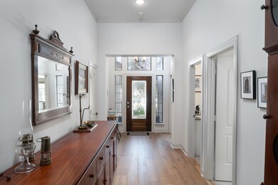 The grand entrance and leaded glass door are flooded with light.