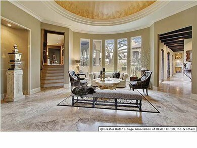 Travertine Flooring in the foyer showcases lighted