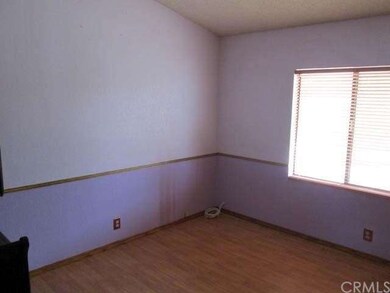 Second bedroom has cute chair rail molding and a w