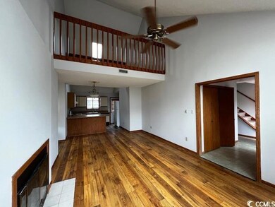 Unfurnished living room with ceiling fan, hardwood