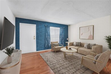 Living area with a textured ceiling, tile walls, a