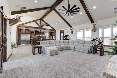 Living room featuring light carpet, beam ceiling, 