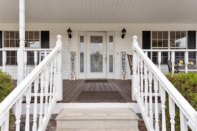 Property entrance with covered porch