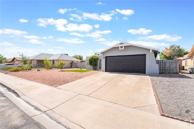 Ranch-style home featuring concrete driveway, fenc
