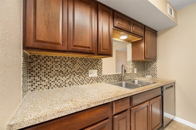 This kitchen features elegant wooden cabinets, a m