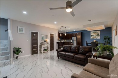 Tiled living room featuring ceiling fan
