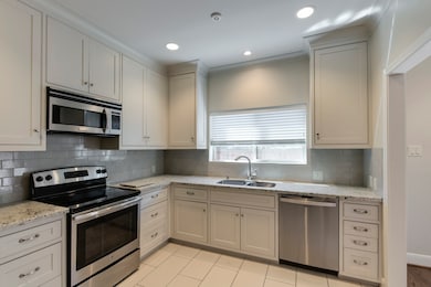 Chef's kitchen has custom cabinets, granite counte