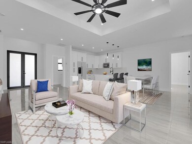Living room with french doors, ceiling fan, and a 