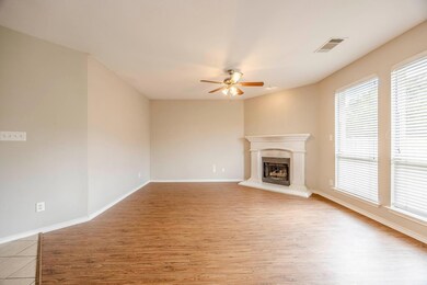 Unfurnished living room with ceiling fan and light