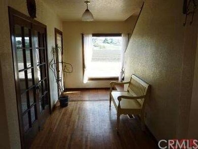 Indoor entry with original oak floors and french d