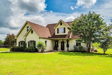View of front facade with stone siding, a front l