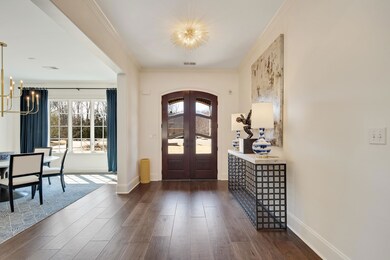 Foyer with arched walkways, french doors, a notabl