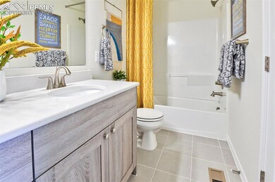 Full bath featuring vanity, toilet, tile patterned floors, and shower / bath combo