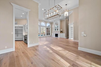 Wide plank wood flooring seamlessly laid throughout the first floor