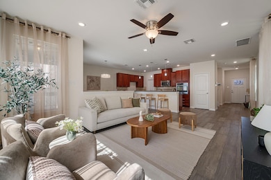 Living area featuring a ceiling fan, recessed lig