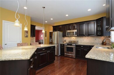 The kitchen includes hardwood floors, maple cabine