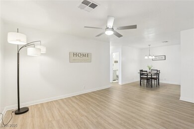 Unfurnished living room with visible vents, basebo