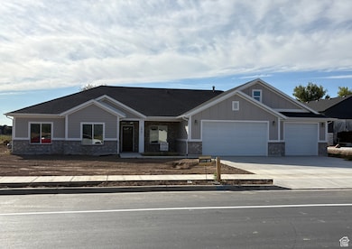 Craftsman-style home with covered porch, driveway, a garage, board and batten siding, and brick siding