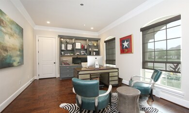 Located on its own just off the entry, the home office features custom built ins and hardwood floors