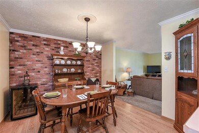 1792 RENEE DINING AREA WITH BRICK ACCENT WALL