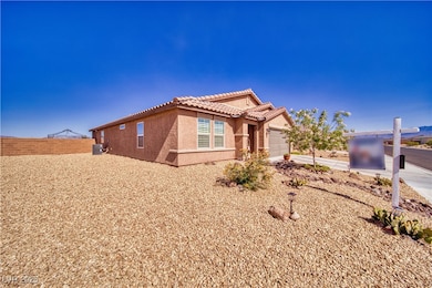 Ranch-style house featuring a tile roof, stucco si