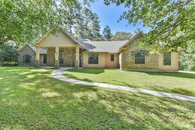 One story home surrounded by trees.