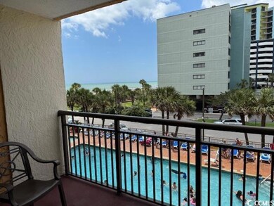 Balcony featuring view of pool