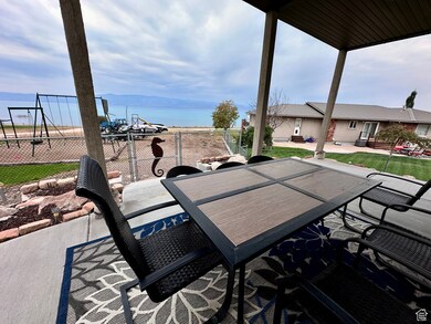 View of patio featuring a water view and outdoor dining area