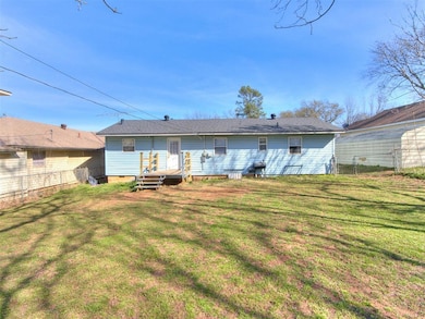 Rear view of property with crawl space and roof with shingles