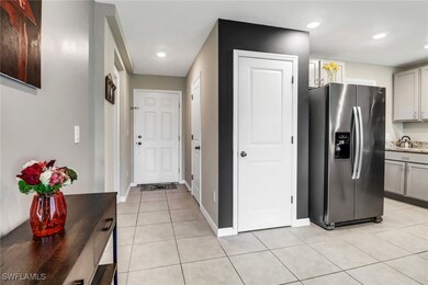 Kitchen with stainless steel fridge, gray cabinets