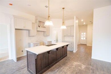 Kitchen with dark wood-type flooring, white cabine