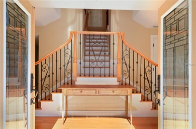 Entry foyer with beautiful staircase.