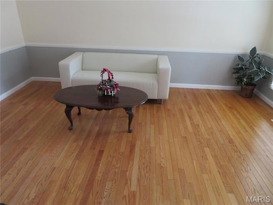 Sitting room featuring light wood-style flooring