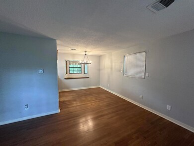 Unfurnished room featuring an inviting chandelier,