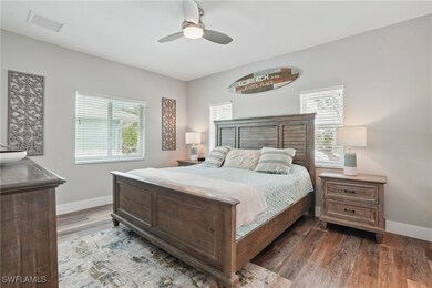Bedroom featuring baseboards, wood finished floors, and ceiling fan