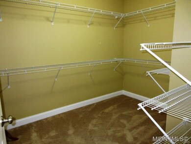 ONE OF TWO CLOSETS IN MASTER