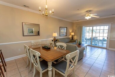 Tiled dining area with crown molding and ceiling f