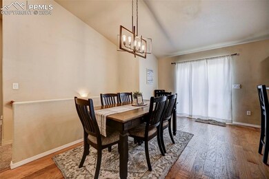 Dining room with a notable chandelier, hardwood / 