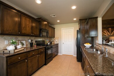 Granite Kitchen with gas range, shaker cabinetry &