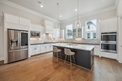 The gourmet kitchen features sleek stainless steel