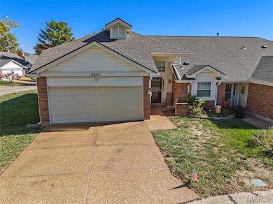 View of front facade with a front yard, brick siding, roof with shingles, and a garage