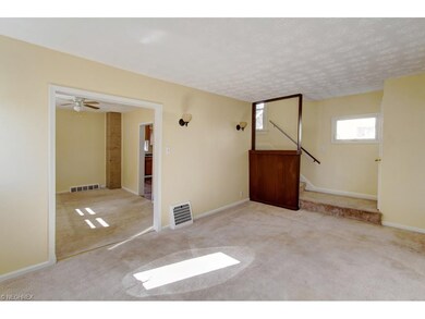 Spacious living room leading to dining room.