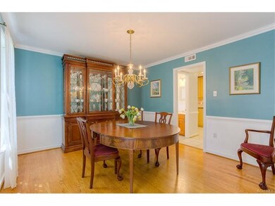 Formal Dining Room with crown moulding, chair rail