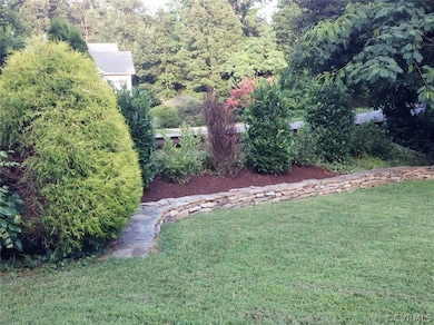 Beautifully landscaped lawn and beds surround the