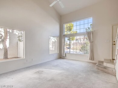 BRIGHT AND LIGHT LIVING ROOM WITH LARGE WINDOWS TO