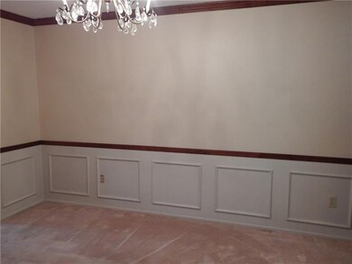 DINING ROOM WITH WAINSCOTING AND CHAIR RAIL.